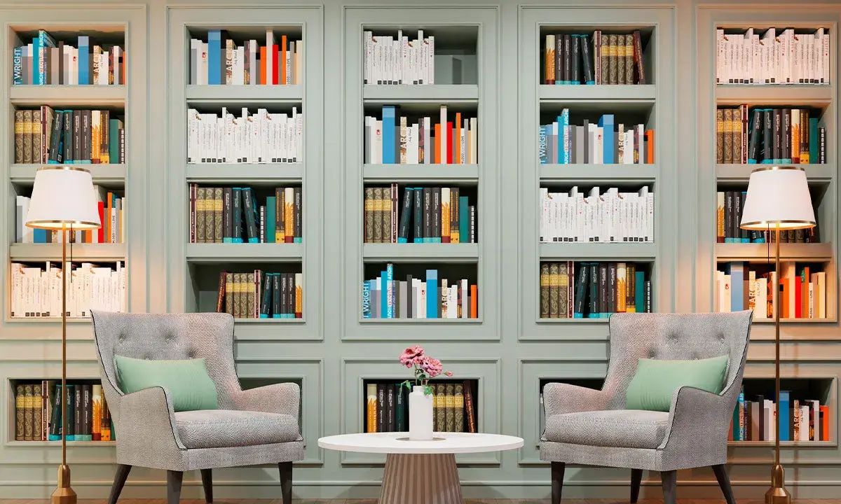 Libreria elegante con libri ordinati, poltrone comode e lampade. Un'ispirazione su come abbellire una libreria con stile e funzionalità.