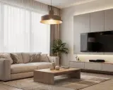 Un accogliente soggiorno con divano beige, tavolino in legno e un'elegante illuminazione sopra il divano che crea un'atmosfera calda.