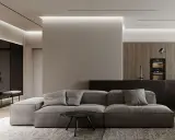 Soggiorno moderno con divano grigio, tavolino nero e cucina a vista. Un pilastro centrale, illuminato da luci a led, offre spunti su come abbellire un pilastro in soggiorno.
