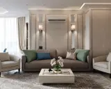 Un salotto con un divano marrone, due poltrone beige e un tavolino bianco. L'arredamento contemporaneo chic è completato da cuscini verdi e blu, un tappeto geometrico e luci soffuse.