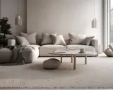 Soggiorno accogliente con divano angolare e tappeto in un caldo colore taupe. Tavolino rotondo con tazza e libro.