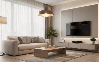 Un accogliente soggiorno con divano beige, tavolino in legno e un'elegante illuminazione sopra il divano che crea un'atmosfera calda.