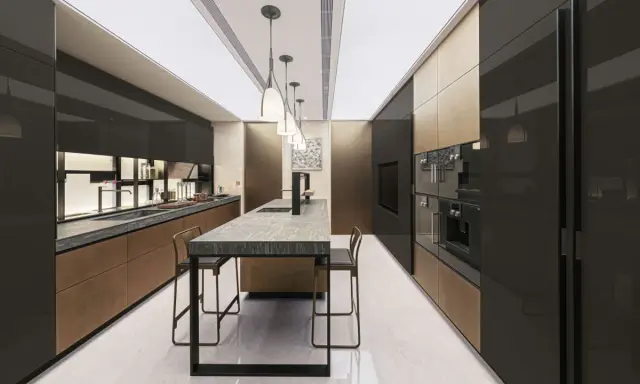 Cucina moderna Valcucine SPA con isola centrale in marmo, pensili neri lucidi e finiture in bronzo.