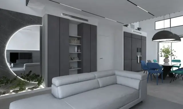 Elegante salotto grigio e bianco con divano moderno, zona pranzo con sedie colorate e un'originale parete a specchio con illuminazione.