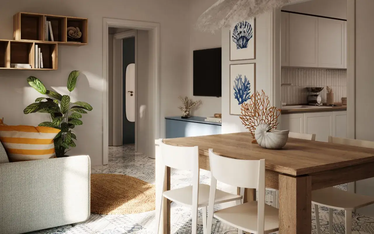 Arredamento casa al mare con idee originali: tavolo in legno, sedie bianche, piante verdi e decorazioni marine.