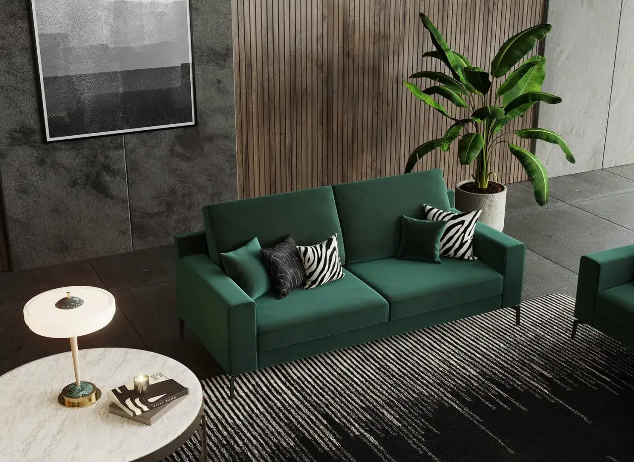 Divano verde smeraldo con cuscini zebrati e geometrici. Un tavolino bianco con lampada e libri. Scopri come lavare il velluto per mantenerlo cos&igrave;.