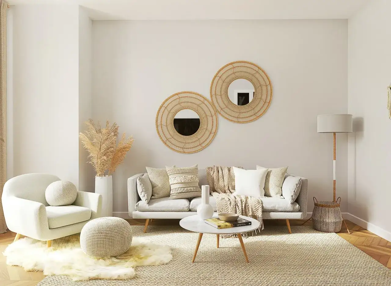 Accogliente foto salotto moderno con divano grigio, poltrona bianca, tavolino rotondo in marmo, specchi intrecciati e decorazioni naturali.