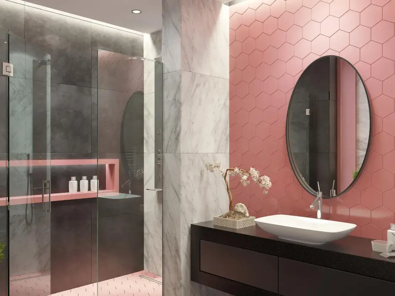 Bagno moderno con pareti rosa a nido d'ape, doccia grigia e marmo. Un lavabo ovale su mobile nero e specchio rotondo completano queste idee bagno rosa.