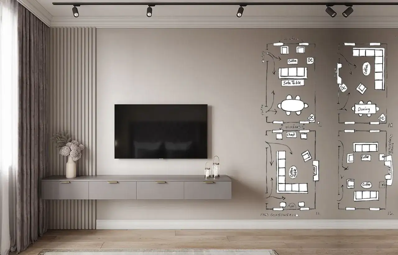Un soggiorno moderno con un mobile TV sospeso e schizzi di planimetrie sul muro. La disposizione del tv non frontale al divano &egrave; una delle opzioni studiate.