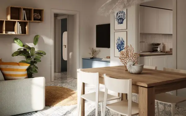 Arredamento casa al mare con idee originali: tavolo in legno, sedie bianche, piante verdi e decorazioni marine.