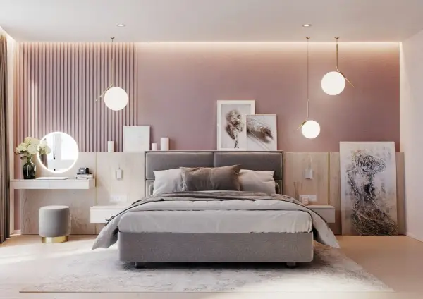 Elegante camera da letto rosa antico e grigio con letto imbottito, specchio rotondo illuminato e opere d'arte astratte.